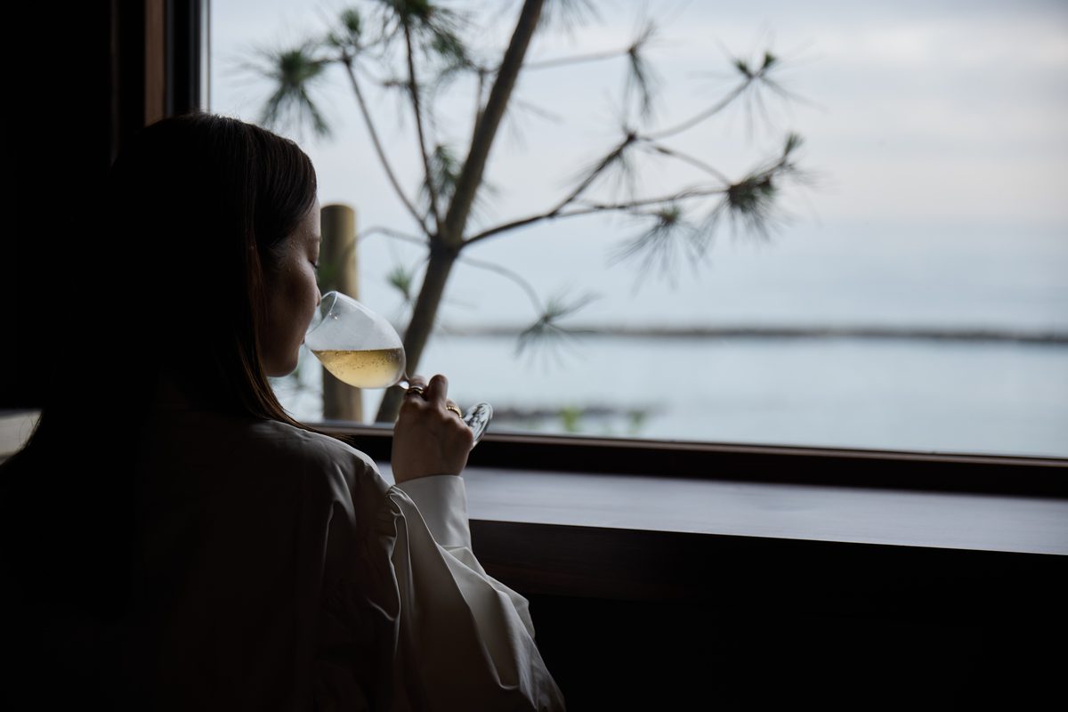 Looking out to sea, glass in hand